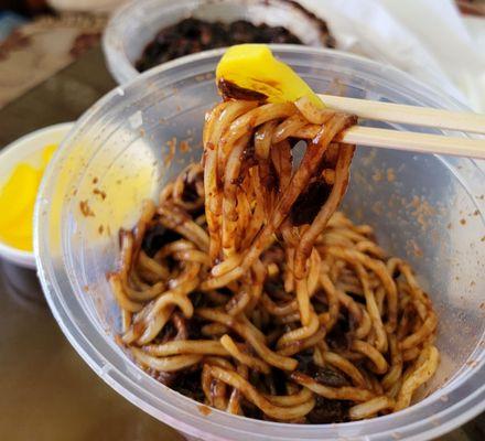 Black bean noodles with pickled radish. The perfect bite