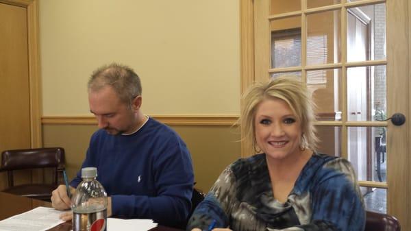 Happy clients at the closing table purchasing a great new home! 