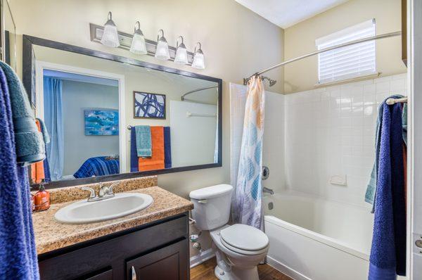 The spacious bathrooms have plenty of storage for all of your needs