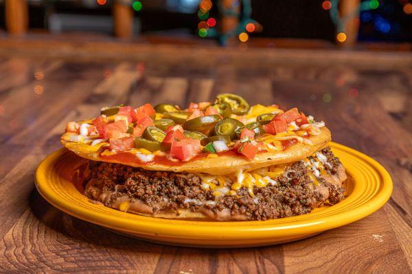 Mexican Pizza! 8" Flour Tortillas, Creamy Refried Beans, Ground Beef, and Grated Cheese. Topped with Enchilada Sauce, pico, and jalapenos