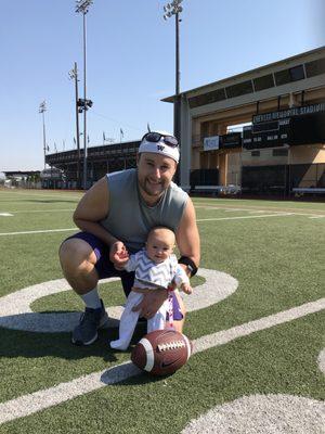 Dr Adam with baby Sophia teaching her to kick field goals!