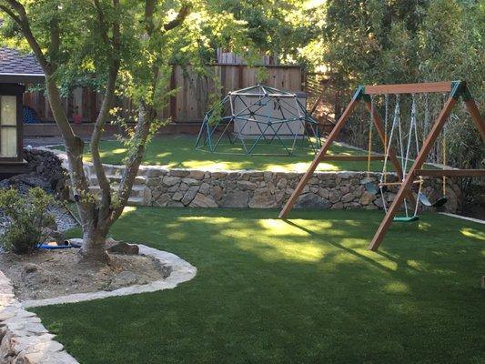 After the drainage went in our Alamo Client had us install some rock walls and artificial lawn in their play new area.