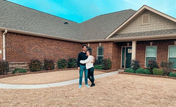 My hubs and I in front of our new home!