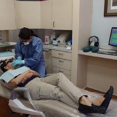 Dr. Beedu, Milpitas Dentist, working with a patient.