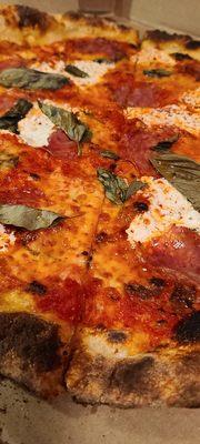 Round pie with soppressata, red sauce, mozzarella & hot honey