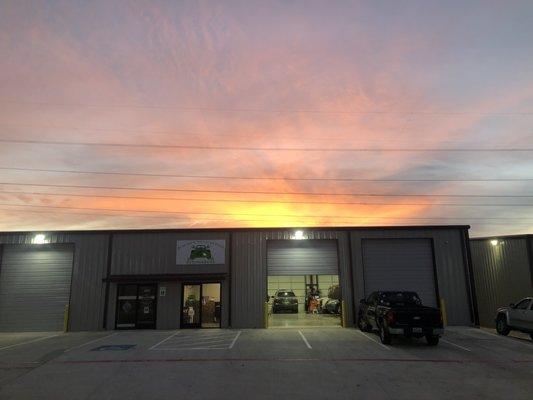 The sun setting over the shop