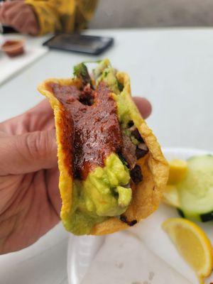 Asada taco with spicy sauce