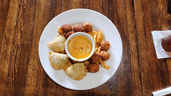 Sampler Appetizer with Crab Cakes, Crawfish Pies, Hushpuppies, Onion Rings & Crawfish Queso