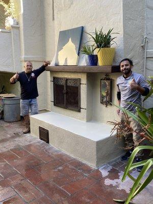 Craftsman Breinner & Moises next to their newly completed work on the Courtyard Fireplace