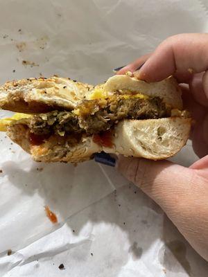 Plant-based sausage and egg sandwich on an everything bagel