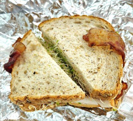 California Turkey (Smoked turkey, swiss chs, bacon, sprouts, avocado on 12 grain bread - no mayo, tomato), $7.99. Very filling.