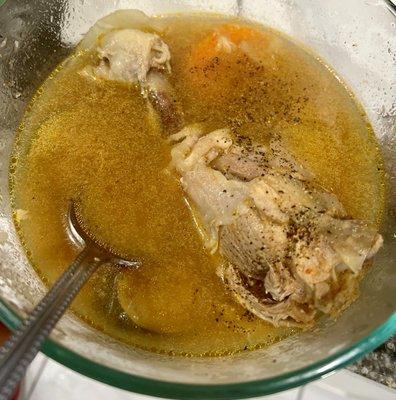 Chicken soup with bone. Black pepper added by diner.
 Sopa de pollo para llevar, con hueso de pollo. El comensal le añadió pimienta negra.