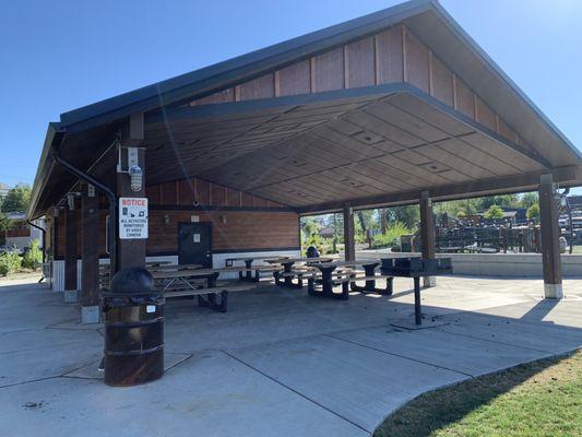 Covered picnic table area with a grill.