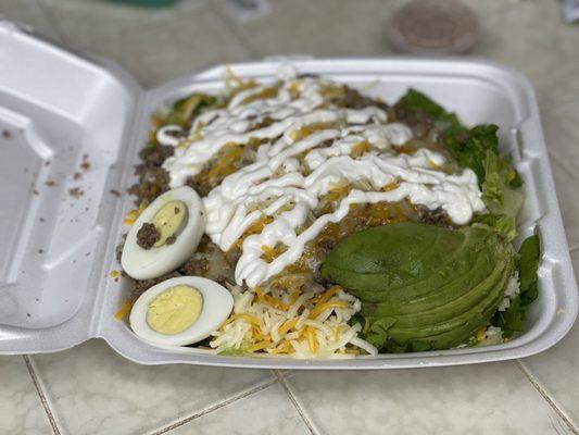 Taco Salad. Not sure why it has a hard boiled egg instead of tortilla chips? But tons of meat and look at the size of that avocado