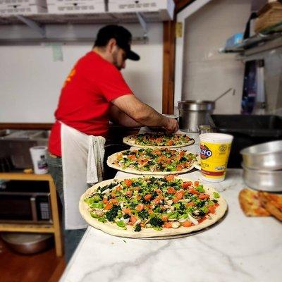 Owner making pizza