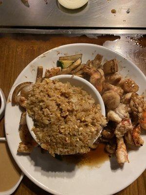 Seafood combination, fried rice, and vegetables.