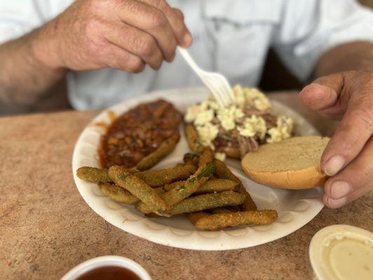 BBQ sandwich plate with baked beans and fried green beans. Sorry my husband was putting the slaw on his BBQ- he was ready to eat