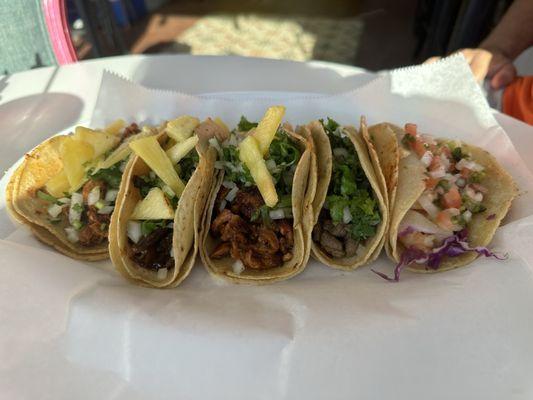 From left to right: tacos al pastor, Al pastor-style mushroom, Justin's Tacos, carne asada, garlic shrimp taco.