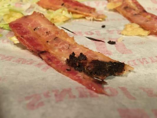 Dark brown sticky substance on spoiled looking bacon covered in black marks and cut #wtf