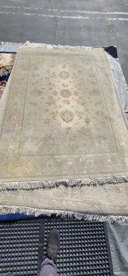 Very dirty wool and silk area rug about to be Dusted (dry soil removal)