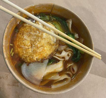 Tomato soup with hand cut noodles, veg, and fried egg.