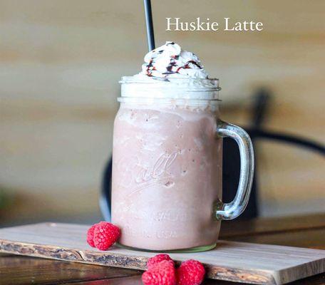 One of our Signature Drinks-- the Huskie Latte. Made with espresso, raspberry, white chocolate with topped with whip and chocolate drizzle!