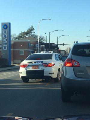 Saw this Globe Taxi speeding down the oncoming traffic lane behind me and nearly collided with a vehicle exiting a grocery parking lot.