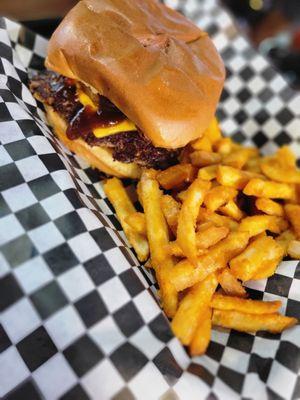 Cheeseburger with bbq and fried onion rings with a side of fries