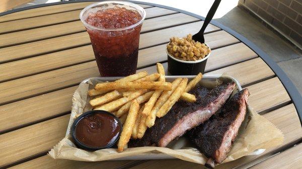 Three ribs, Cajun fries, and cheesy corn on the covered patio