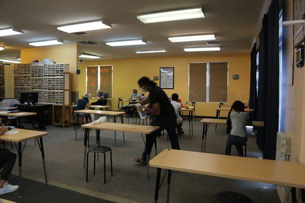 Cleaning after each student comes through.