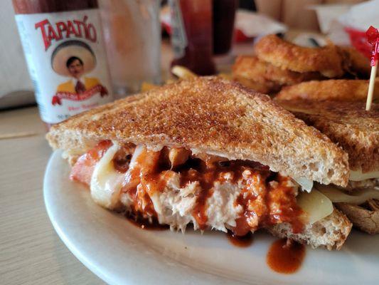 Tuna melt sandwich (added Tapatio sauce) with half fries half onion rings