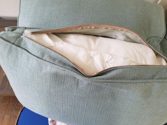 expensive sofa pillows...staples rather than sewn seams. note if unzip, loose cotton gets stuck in zipper. Saw in other store sofas later.