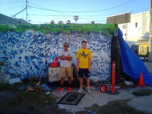 The boys in front of the spray painted waves at Pat's