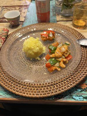 Curry fish, turmeric rice, and stir fry chicken, peppers and cashews. Sweet sticky rice with strawberry and persimmons for dessert.