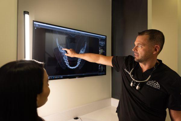 Dr. Bennett explaining veneers to Monica. She loves her new smile!