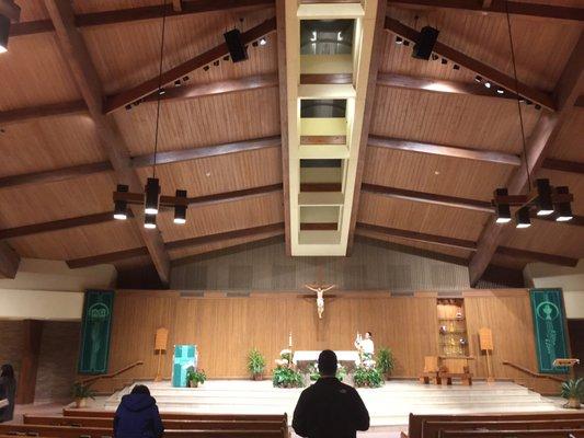 Vertical wood slat wall in front behind the alter