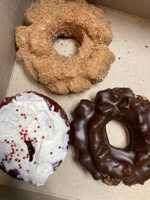 red velvet donut with cream cheese icing. Chocolate covered donut. Cinnamon sugar donut.