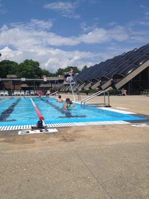 Outdoor pool, indoor building in background