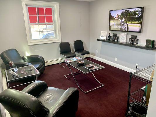 Cozy waiting room with TV and refreshments!