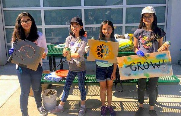 Students and siblings at a campus art and sustainability event