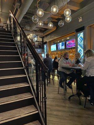 Bar area, stairs lead to upstairs seating