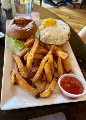 Burger with fried egg and fries