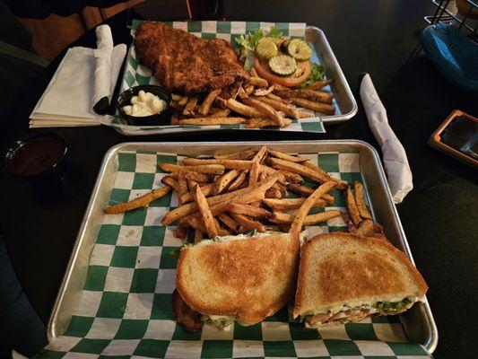 In the distance a giant pork tenderloin samich, up close a turkey melt.