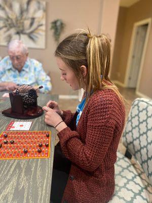 Noble Hospice volunteer hosting a game night.