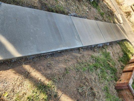 Offshoot of sidewalk path leading to shed pad.