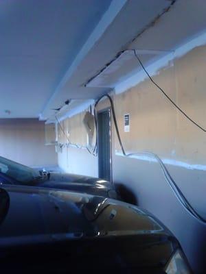 parking lot, unsafe to have wires hanging, and you can slip on the gas leaks