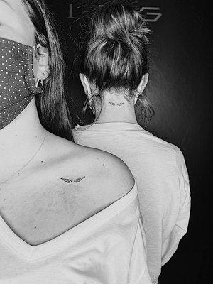 Matching wing tattoos