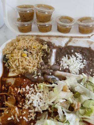 Chicken enchiladas, rice, beans, salad and habanero sauce.