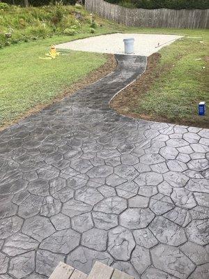 The continued you patio, with sidewalk to the future shed