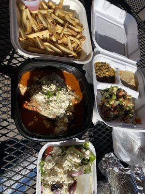 Homemade Moussaka, 3 appetizers (hummus, salata mishya, tabouleh) French Fries, and Greek Salad